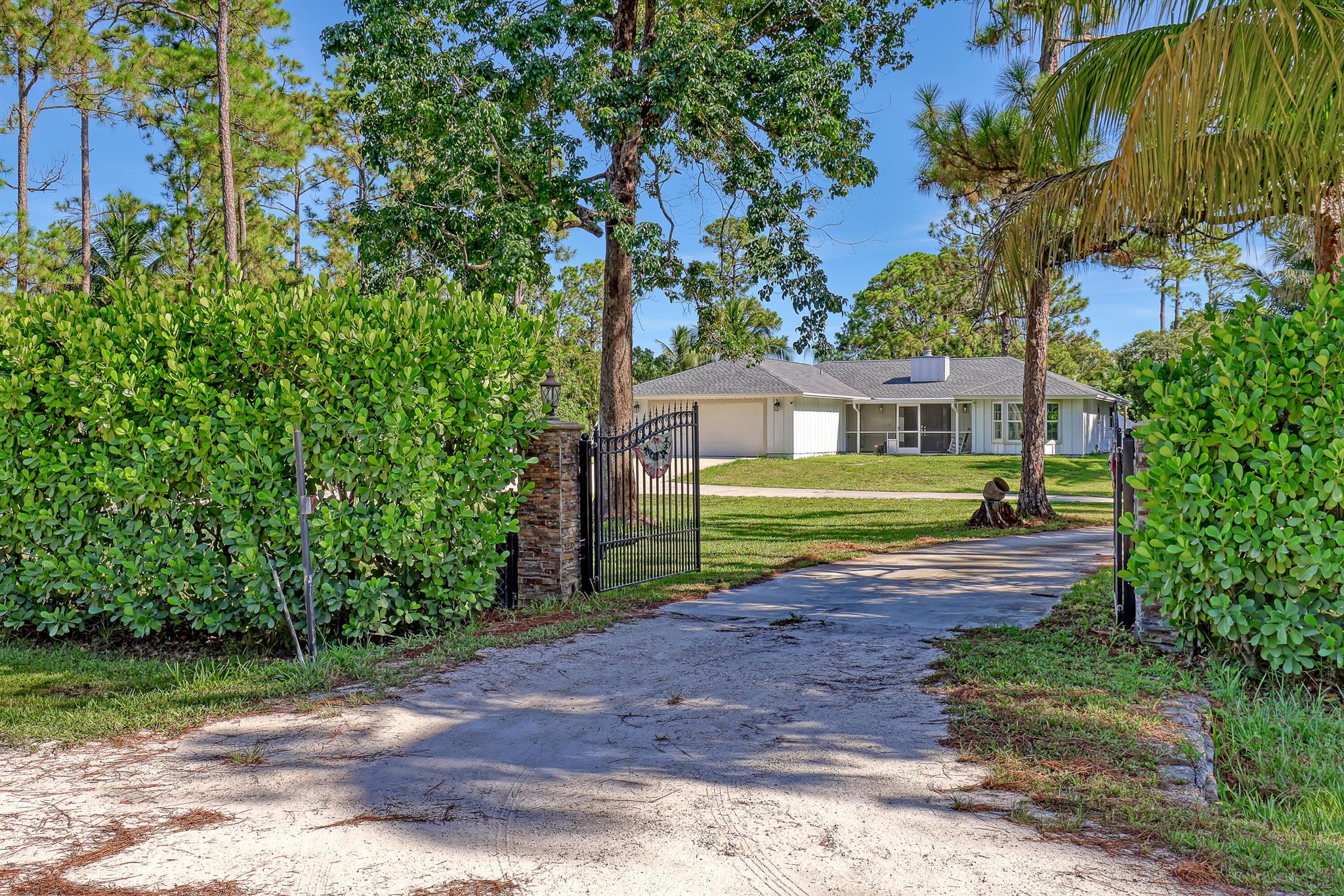 Come and explore this inviting 3-bedroom, 2-bath home that also includes a versatile den (used as 4th bedroom). As you approach, the lengthy concrete driveway welcomes you, leading up to a spacious front porch and elegant double wood doors. Stepping inside, you'll discover an open kitchen that seamlessly flows into the living room. The living room features French doors that open onto the open porch, perfect for relaxing by the fireplace on cool evenings.Step outside to the lanai, where you'll find a bar that overlooks the stunning inground pool and jacuzzi. With impact glass windows, this space is perfect for entertaining guests or enjoying a quiet evening. The lanai offers a seamless blend of indoor and outdoor living, making it an ideal spot for relaxation and social gatherings.