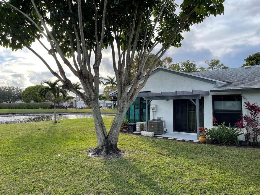 This single-level villa in a 55+ community boasts an abundance of space, thoughtfully designed for comfort and relaxation. Natural light floods through all-new hurricane-proof windows, illuminating the spacious interior. The home consists of a large living room/dining area and a split floor plan with two large bedrooms.  The master has a large walk-in closet and master bathroom. The kitchen opens up into the dining/living area. The enclosed lanai is complete with new high-impact hurricane proof windows and an electric split unit system for heat and A/C. The roof was replaced in 2019 and the hot water tank was replaced in 2022.  New washer/dryer as well. Close to shopping and restaurants with easy access to the turnpike.