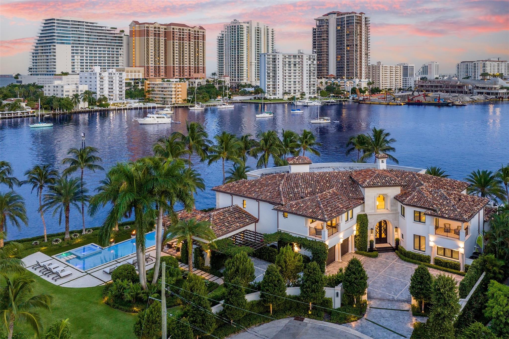 Step into a world of private island allure at this exceptional point lot crafted along the shores of the Intracoastal in the prestigious security patrolled Seven Isles neighborhood. This expertly manicured, gated, RARE double lot spanning over a half acre, boasts two pools, covered entertaining areas, ample room for expansion, & 325' of highly desirable SE exposure WF. Find timeless yet transitional elegance paired with the finest finishes throughout. Upstairs, find an oversized Primary Suite with panoramic views and a stunning private terrace. 2021 Renovations by Gulf Building include top-of-the-line construction materials, finishes, & security. Please refer to the last photos on the listing for Architect's proposed +/- 2500 AC SF addition and features.
