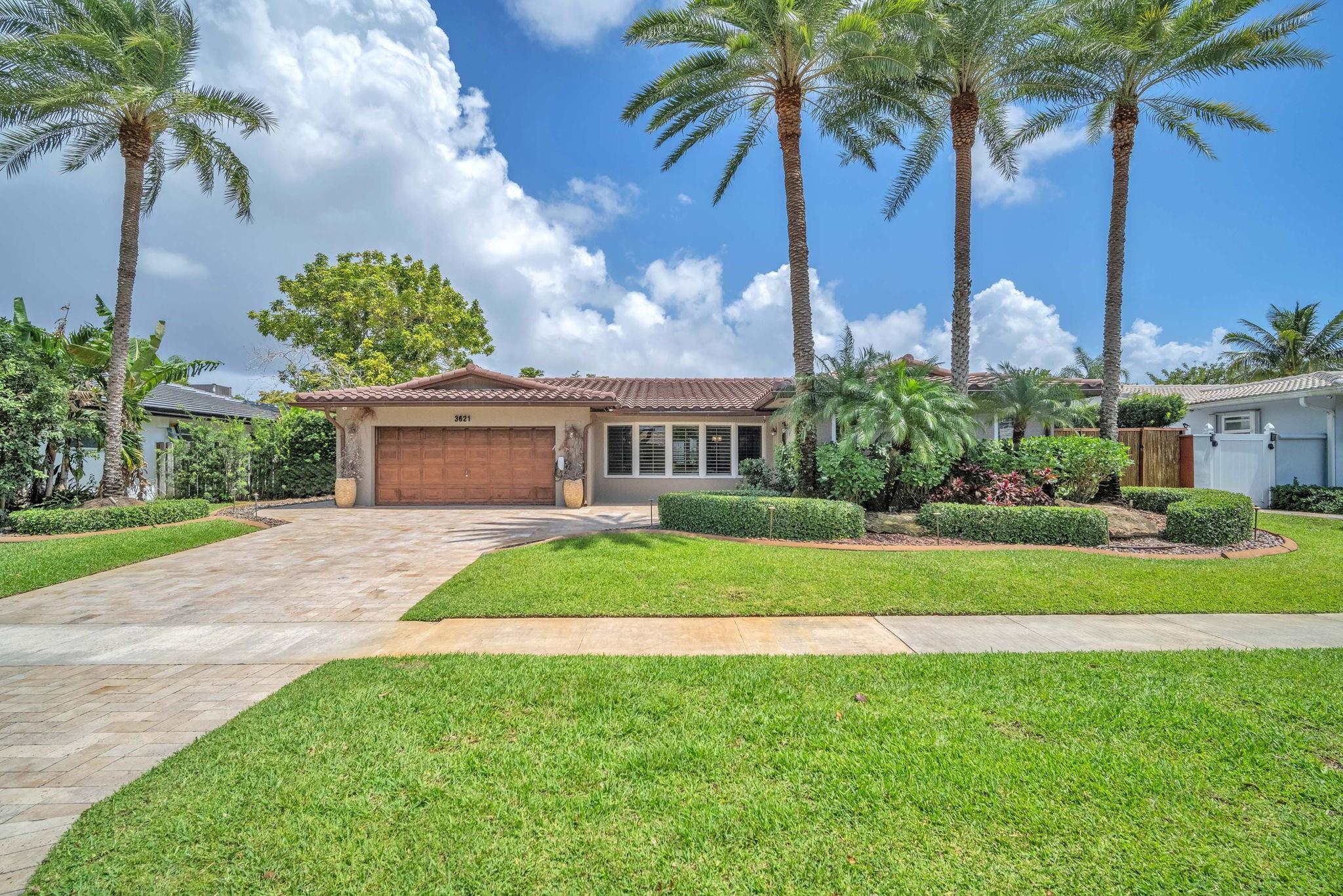 Discover this beautifully upgraded 4BD/3.5BA home in Emerald Hills, where indoor elegance meets outdoor luxury. Situated on a quiet, tree-lined street with lush landscaping, this home offers a perfect blend of comfort and style. The backyard is an entertainer’s dream, featuring a heated pool with travertine pavers, a tiki hut, and a fully equipped outdoor kitchen with a premium propane grill, sink, refrigerator, and ice machine. Inside, enjoy hurricane-impact windows, plantation shutters, and a brand-new kids’ bathroom. Recent updates include new plumbing 2018, flat roof re-coated in 2023, and a split AC unit installed in 2022. The 2-car garage offers a sealed floor and built-in workbench. Offering privacy in a prime location this home is 5.3 miles to the beach and 2 miles to the I-95.