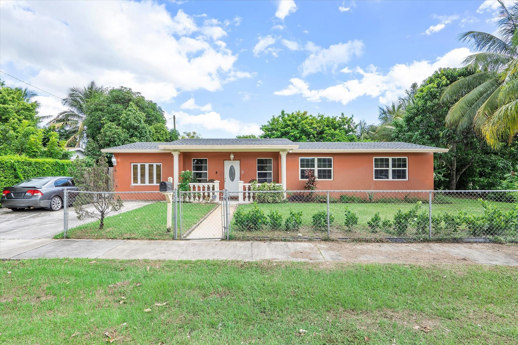 Great opportunity to own a spacious corner-lot home in Miami with endless potential! This residence features multiple living areas, a formal dining room, and an updated kitchen with granite countertops, wood cabinetry, and stainless steel appliances. The main home offers comfortable bedrooms and baths plus an attached efficiency with kitchenette—ideal for in-laws, guests, or rental income. Enjoy a huge fenced backyard with mature trees, patio space, and storage structures—plenty of room to entertain, garden, or add a pool. Owner-occupied and needs a little TLC, making it a perfect canvas to personalize. Convenient to highways, shopping, dining, and schools.