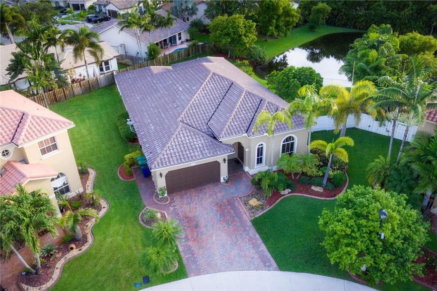 Immaculate and exceptional 4 bed/3 bath 2 car garage, waterfront home in serene ROYAL GRIFFIN ESTATES. Beautifully placed in a quiet cul de sac. Light & bright spacious floor plan w/ tall ceilings and porcelain tile throughout living areas with wood flooring in the bedrooms. Gorgeous open kitchen with granite, SS appliances and cherry cabinetry. Large fenced yard, generous covered tiled patio and room for a pool. New AC, lighting, fans, garage door opener, landscaping, and so much more..details details!
