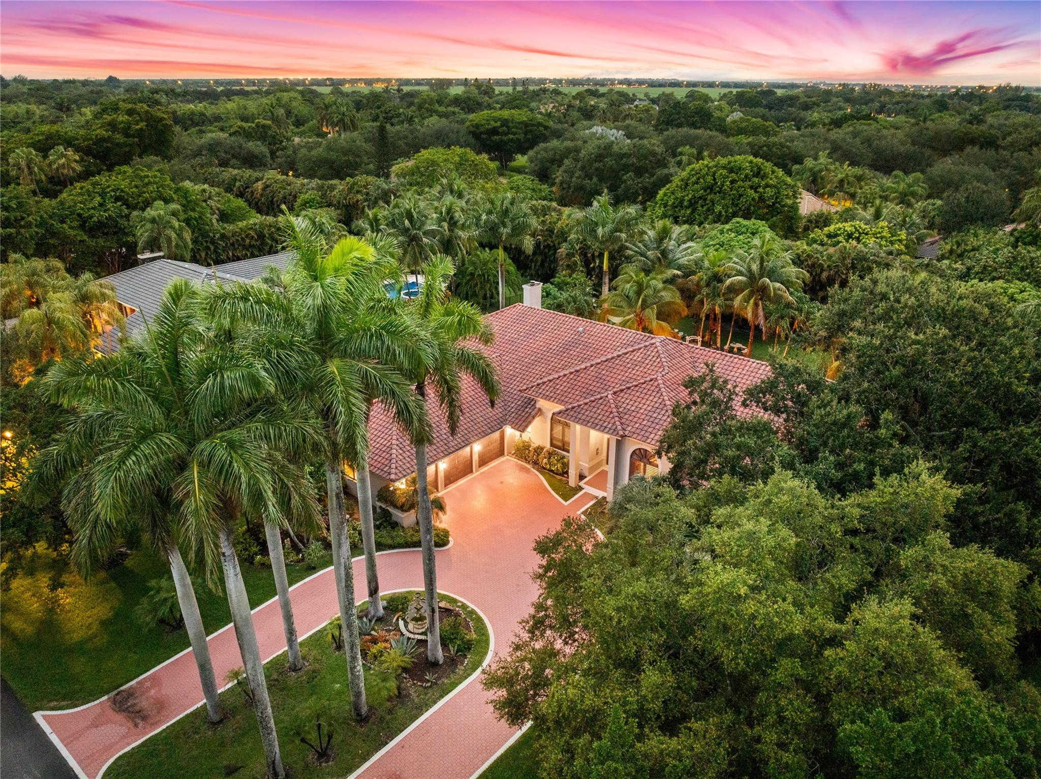 Set on a ¾ acre lot, deep in community, insulated from roads in prestigious Cypresshead –Parkland fantasy! Dazzling ranch-style fp features views of pool & lush tropical oasis from entire back line of the home. Upgrades to kitchen feat. high-end finishes, materials & appliances. The 5th-bdrm, now equipped w mahogany built-ins as formal office/study, may easily be converted for other use. Newly epoxied garage, 13-year-old roof, updated diamond brite pool++ (full list in supplements). Savvy buyers are looking for THIS lot when they look in Parkland. Add a home addition, extension & ENJOY your own private, romantic garden oasis complete with various fruit trees, tropical plants; adorned with trellises & pond. Parkland's charm & character embodied- lot largesse, character, charm.