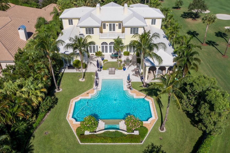 Spectacular Custom Estate situated on nearly an acre home site with panoramic golf and lake views!  This exquisite home was newly constructed in 2009 with the finest workmanship and the highest level of quality and finishes. The 10,000 sf + residence features extraordinary architectural detail throughout including soaring 14ft ceilings, exposed rich beams, elegant marble flooring, French-styled impact glass doors and windows that look out to the pool, spa and scenic golf views.  The home has a very functional floor plan with a sprawling downstairs master suite with enormous his and hers walk-in closets, grand and luxurious his and hers bathroom, onyx morning bar in the mater foyer and spacious sitting room. The spacious office/library with detailed ceilings and built-ins is also downstairs