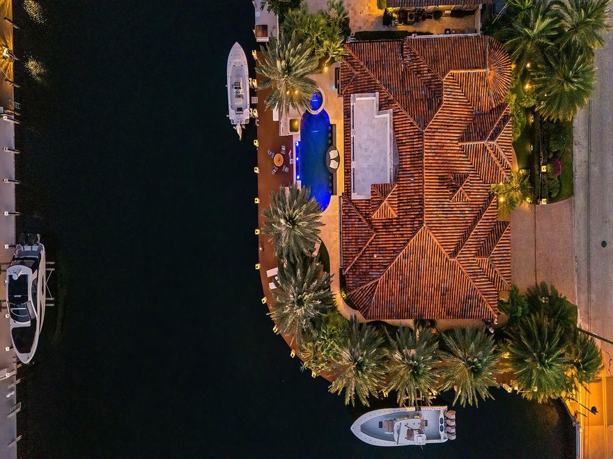 This exceptional waterfront residence offers a rare opportunity to own a 2016 custom-built home on a truly premium lot with 220 feet of water frontage, set within a wide turnaround basin ideal for larger vessels. Thoughtfully designed with refined architectural detail throughout, the home showcases clean lines, custom finishes, and a layout that balances elegance with functionality. The backyard is a resort-style retreat with a pool and spa overlooking wide, open canal views, complemented by expansive areas for dining, lounging, and entertaining. With seamless indoor-outdoor living, exceptional boating access just minutes from the Hillsboro Inlet and ocean, and architectural details that set it apart, this home delivers a truly rare waterfront lifestyle.