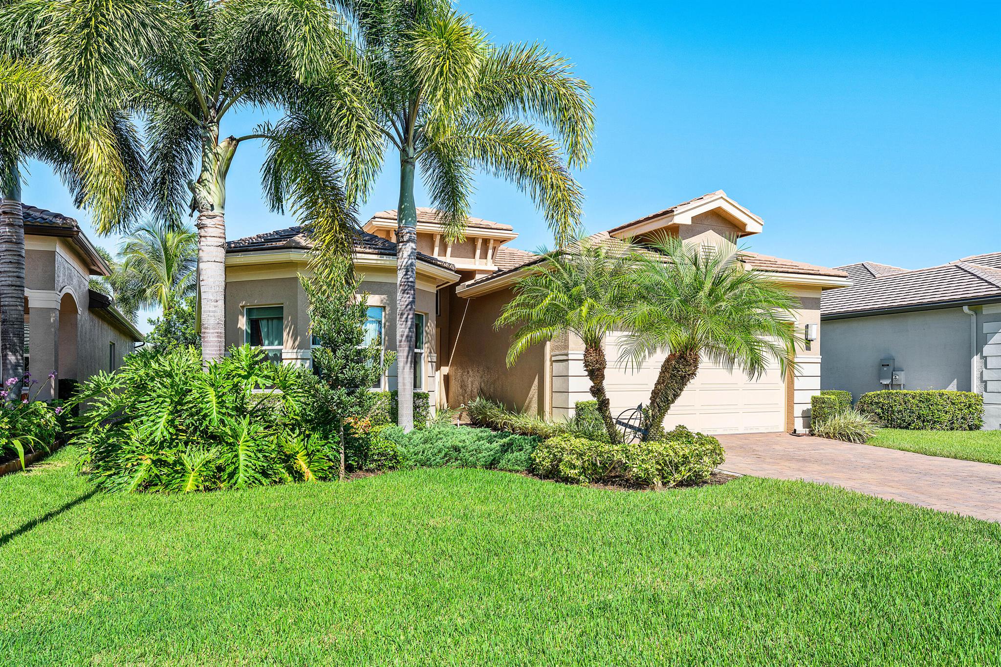 This lushly landscaped 3 bedroom + den, 3 bath Bimini model sits on a lovely lakefront lot. Features include impact windows, open floor plan, tile in main living areas, recessed lights, upgraded baths and more! The gourmet kitchen has white wood cabinets, quartz countertops, glass tile backsplash, built-in pantry cabinet, stainless steel appliances and the convenience package which includes a built-in silverware tray, tray cabinet, pullouts, drawers, and trash and recycling cabinet. Enjoy the separate breakfast area and snack bar for casual dining. The dining room is perfect for holiday dinners. The great room is open to the kitchen and dining room. The master bedroom has outfitted closets and a luxurious bath. You'll love sitting on the covered, screened patio overlooking the lake.
