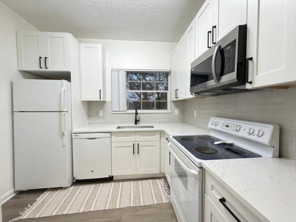 Photo of 651 CYPRESS LAKE Boulevard #L, Deerfield Beach, FL 33064 (MLS # B26092602)