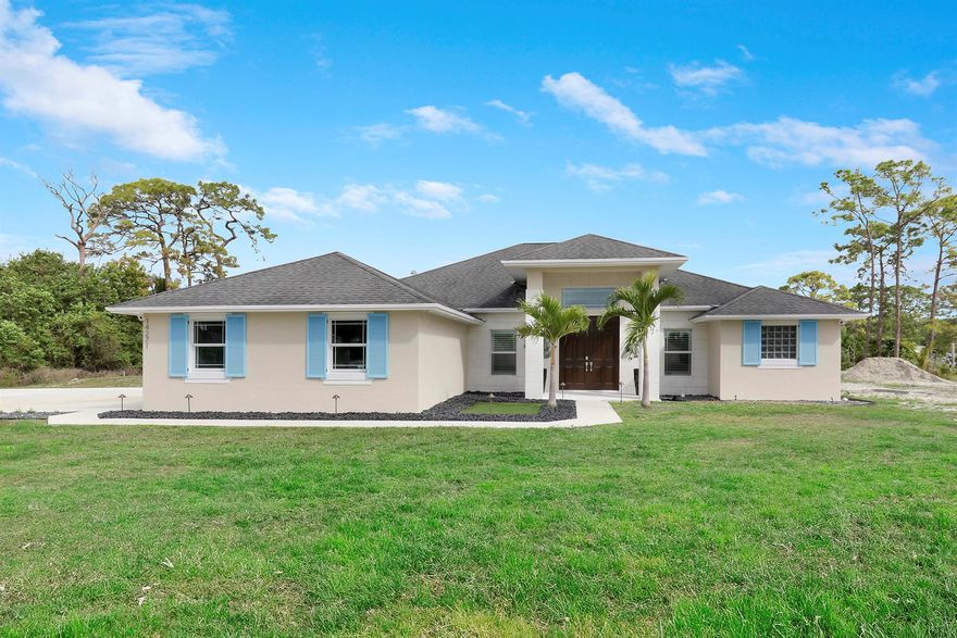 A SHOW STOPPER! Unbelievable home loaded with upgrades! This beautiful CBS home was built in 2018 and sits on over an acre of land in the heart of Loxahatchee. Walk inside to find yourself greeted with the newest trends in flooring and finishes complemented by an open floor concept perfect for entertaining. The kitchen has been recently updated with high-end appliances, granite throughout, dual Sub-Zero refrigerators and an oversized island fit for a chef! This home is equipped with a custom pool with sun deck which was built in 2022 making the back yard a private tropical oasis perfect for entertaining! This home is complete with hurricane impact windows, energy efficient appliances along with a reverse osmosis system. Call for a private showing today before this house goes pending!