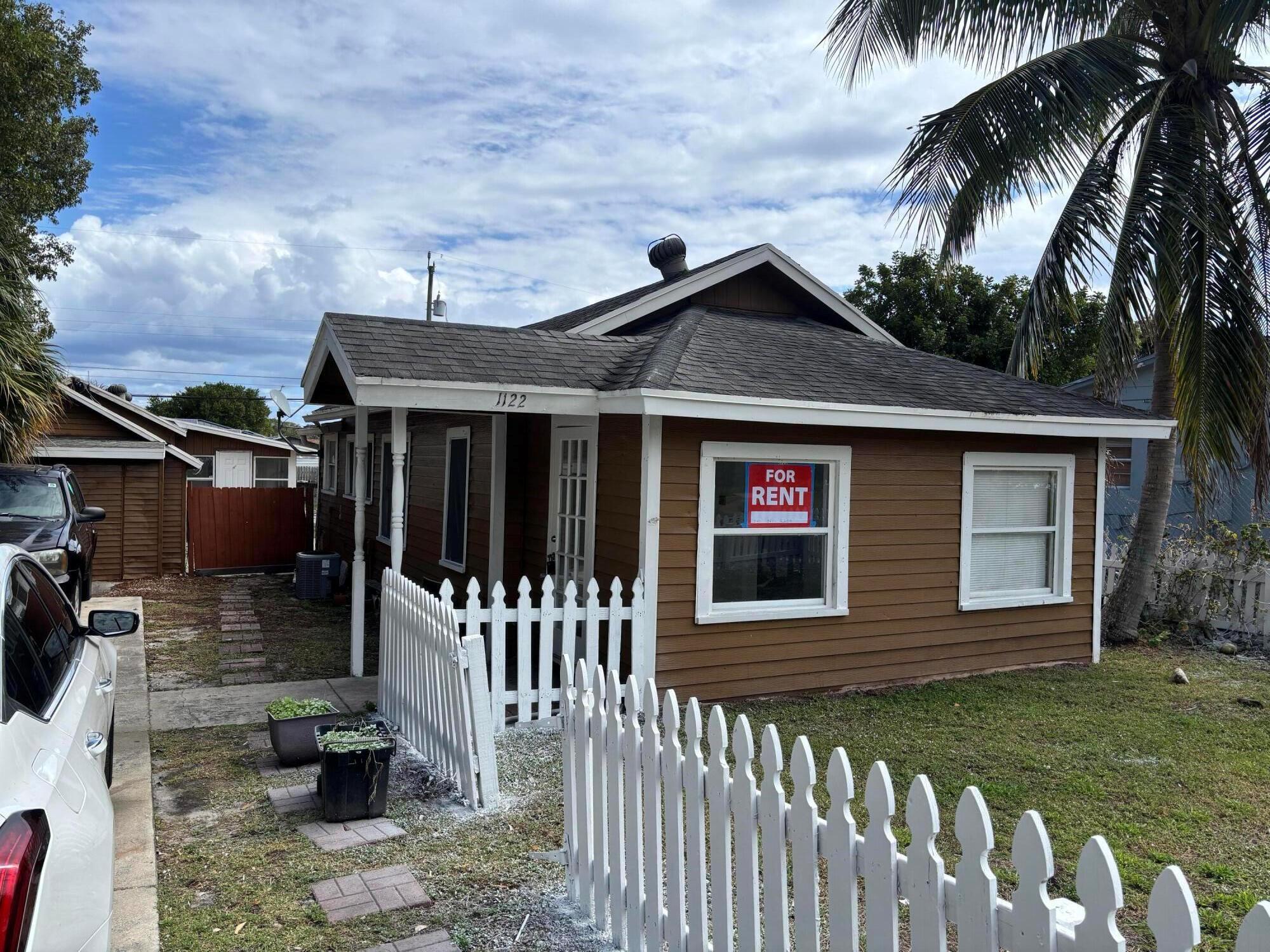 Single family home for rent! This home has 5 bedrooms and 2 bathrooms. There is a main house, a back cottage with a garage located in Lake Worth. Additional features include a front fenced in yard, a long driveway leading to a garage, and a newer hot water heater.