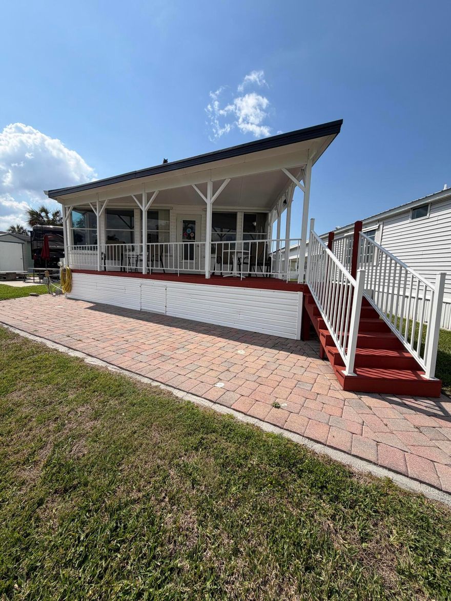 Ancient Oaks RV Resort- Waterfront Living! Welcome to this pristine 2 Bed 2 Bath MH situated on the pond. This well-maintained home offers comfort, space, and resort living all in one. Enjoy relaxing mornings and evenings on the covered back porch overlooking the water with beautiful pavers. This spacious layout has carpet throughout, ample storage and upgrades including two hot water heaters, reverse osmosis system, and a water softener. New front porch in 2022- covered and has composite deck for easy maintenance and a metal roof. Resort amenities include a heated pool, pickleball courts, shuffleboard, and a marina with a fish cleaning station for the fishermen. Fur babies welcome!