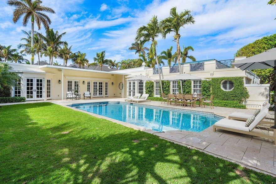 Welcome to 168 Kings Rd, a Classic Palm Beach Regency home located in the prestigious Estate Section of Palm Beach. This residence sits on an oversized 16,000 + sq ft lot and features a versatile 5 bedroom, 6.5 bath layout with generous ceiling heights and spacious rooms, making it an ideal space for entertaining and hosting guests. The backyard offers a private retreat centered around a large, heated saltwater pool, complete with a covered area for dining and relaxation. Modern amenities include dual bathrooms in the primary suite, a wet bar, 1,000 bottle wine storage, impact glass, full house generator and air-conditioned 2-car garage. Conveniently located to all the Palm Beach lifestyle has to offer.