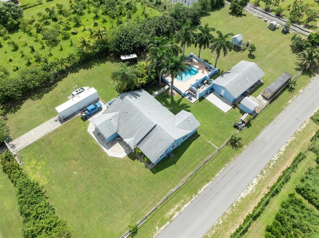 Beautiful home on almost 2 acres with pool and UPGRADES ready for move-in!! Gorgeous marble floors throughout and granite countertops. Transfer switch, pipes and reinforced location for full house generator already in place! Great for large families! Newer roof, and Hurricane Impact Windows. New Diamondbrite for pool and outdoor slip resistant tiles in 2022. Easy Water Triple filtered Water Purification System.