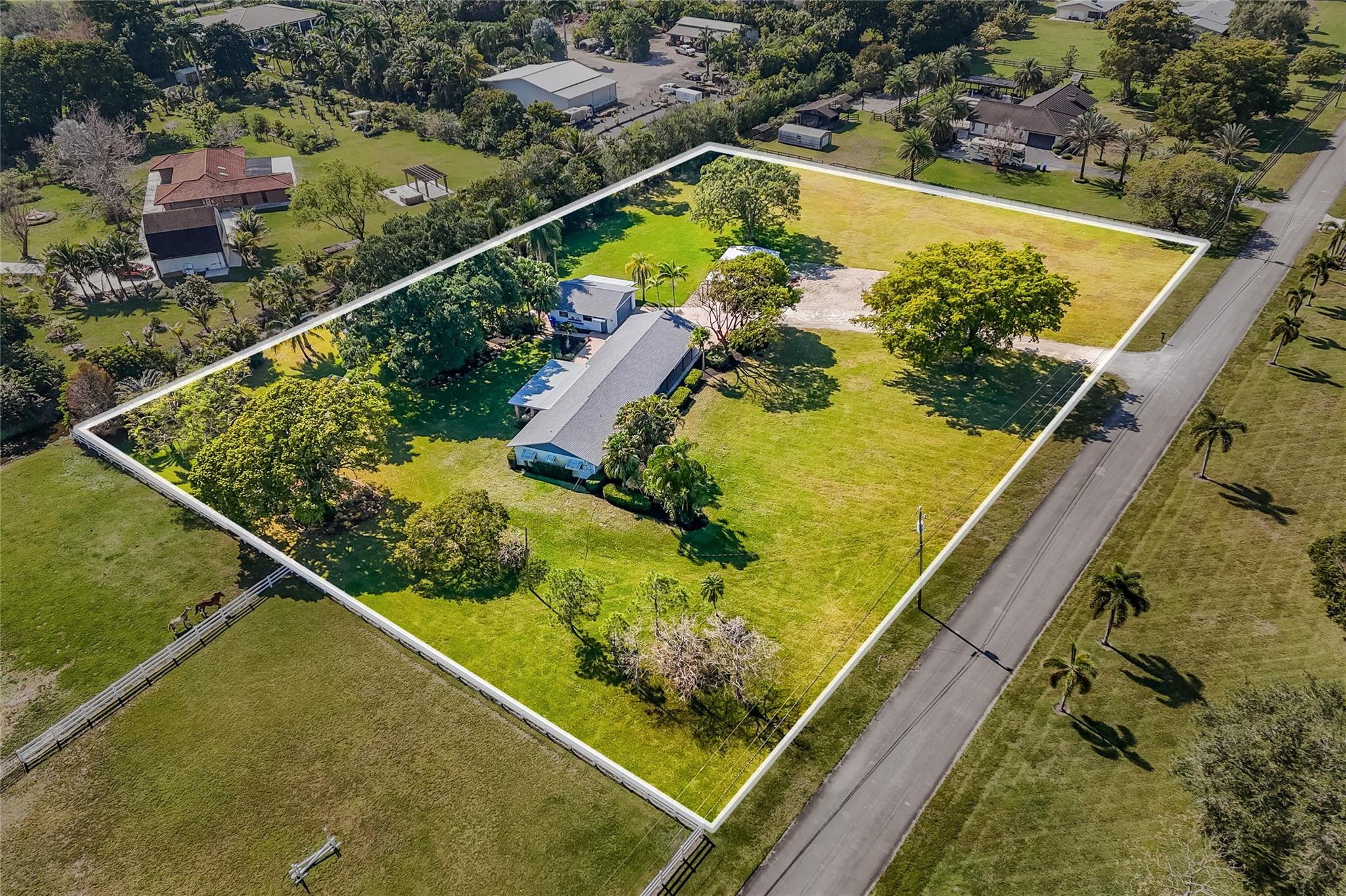 2.8 acres in the desirable community of Rolling Oaks, comes with a charming ranch-style home. Located within the Town of Southwest ranches, it is horse & ranch-friendly. Current use is 3 Bed/2 Bath main home w/ ample living and dining areas and a dedicated office space. Additionally, an adjoining 2-Bed/1 Bath suite with its own kitchenette and entrance provides ample space for extended family or guests. Included are an oversize 2-car garage with a designated mower storage area and adjoining small livestock stall. An additional freestanding metal "toy shed" or 2-car garage provides extra storage or the perfect workshop. Recent updates include a brand-new roof in 2023 and fully replaced plumbing beneath the home. Perfect for a family looking to make this into their dream home and ranchette.