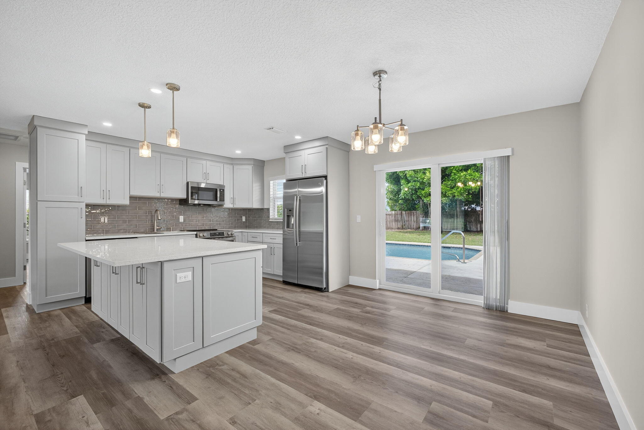 Welcome to La Mancha in Royal Palm Beach! This 3BR/2BA single-family home has it all--brand-new open kitchen with island, new GE stainless appliances, new updated baths, new luxury vinyl floors, new impact windows, and a new AC/duct system. Enjoy Florida living with your private pool, spacious fenced in backyard (perfect for pets, toys, & entertaining), plus modern updates throughout. Just steps to the park, dog park, tennis & basketball courts, Village Golf Course with shopping & dining minutes away. No detail left undone--come make this home yours!