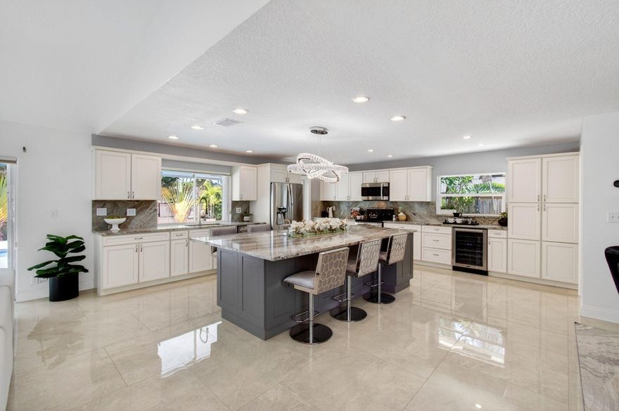 Elegantly remodeled  4 bedroom residence with a newer roof (2021) and hurricane protection. This sophisticated home boasts soaring cathedral ceilings, abundant natural light, neutral tones and large 30" tile flooring-no carpet or sunken/step down rooms. The kitchen is as functional as it is beautiful and features an expansive 10' island w/seating for 8 & extra storage, warm custom cabinetry, newer appliances including beverage cooler. The grand great room highlights a decorative fireplace and recessed lighting. Outside enjoy the sparkling swimming pool with a premium travertine paver deck and a serene covered patio. Pheasant Walk is a premier neighborhood in Central Boca Raton with a community park and A rated schools. Spotless and move in ready.