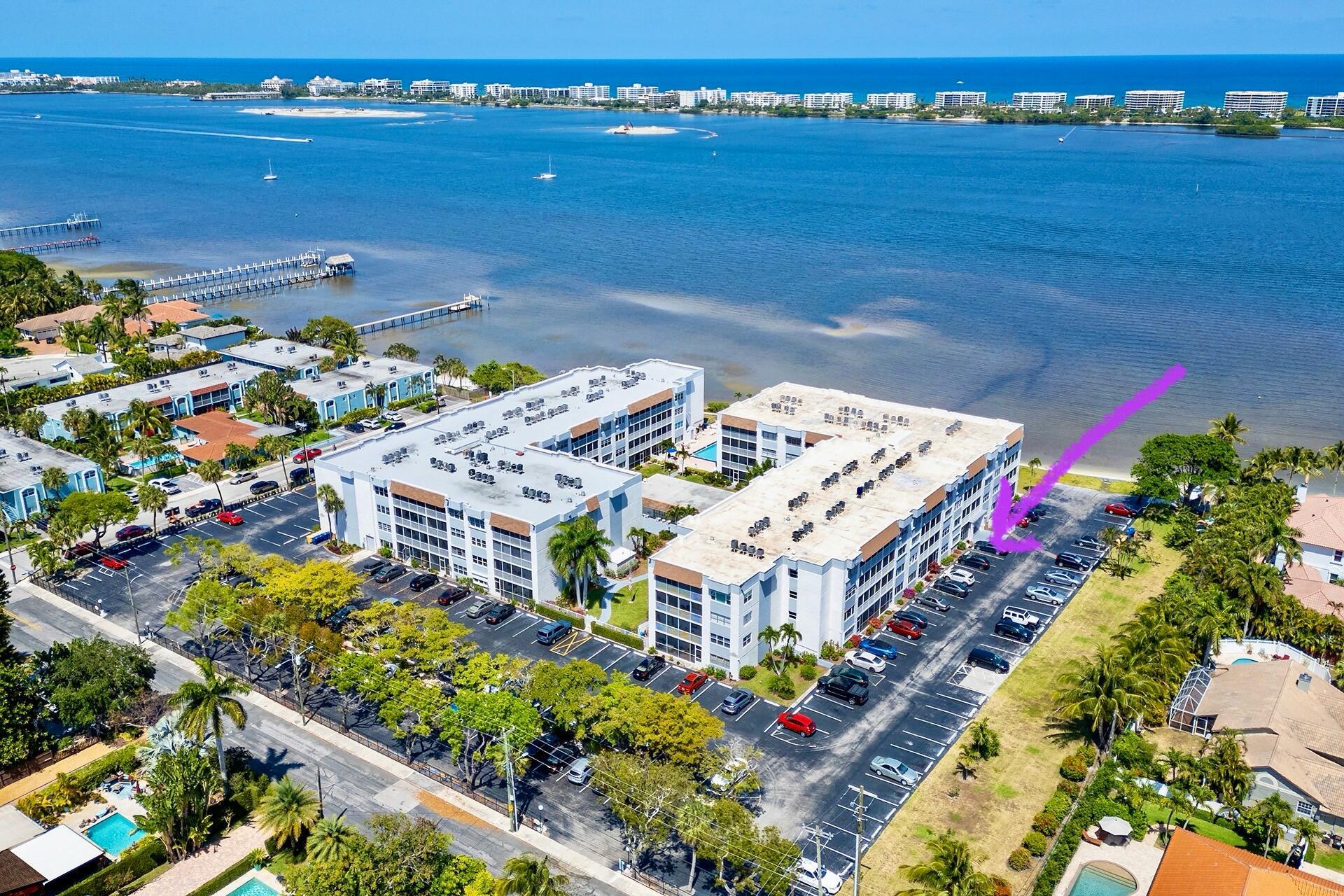 444' DIRECT WATERFRONT! UNIQUE MIRROR IMAGE BUILDINGS COMPLETELY REBUILT IN 2023. ALL INSPECTIONS PASSED, IT'S LIKE A NEW BUILD! Over 55 with a sandy beach on the Intracoastal Waterway. First floor updated 1 bed, 1.5 bath with a view! Private entrance from the parking spot right outside to the gorgeous Art Deco door. Beautiful kitchen w granite countertops, glass tile backsplash & newer appliances. Must-have 1/2 bath & ensuite updated with floating vanities. Impact glass throughout for safety, quiet and cleanliness. RO filtered water flows from the taps! Sparkling heated waterfront pool, 5 Marinas nearby, public boat ramp, municipal Golf Course, famous Lake Worth Beach events, restaurants, shopping, nightlife, culture. It's time...leave the stress, come decompress...LOVE WHERE YOU LIVE!