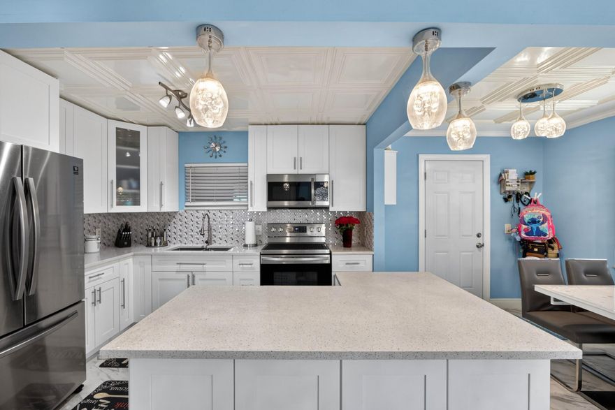 Beautiful, completely remodeled single-family home located in the heart of West Palm Beach! Just minutes from Rosemary Square, pristine beaches, I-95, major shopping centers, downtown, Palm Beach International Airport, and the exciting new Nora District. This move-in ready home features a modern open layout with tile flooring throughout, a fully upgraded kitchen with quartz countertops, sleek cabinetry, and stainless steel appliances. The bathrooms have been tastefully renovated with high-end finishes, offering both style and comfort.  Enjoy a spacious driveway and a large backyard with plenty of room to build your dream pool—perfect for entertaining and family gatherings. The home also boasts a covered rear porch with a fully equipped outdoor kitchen, ideal for hosting guests year-round.  Additional upgrades include a new A/C system and a newer roof for peace of mind. Washer and dryer are included. Don't miss this incredible opportunity to own a beautifully upgraded home in a prime location. Schedule your showing today—this one won't last!