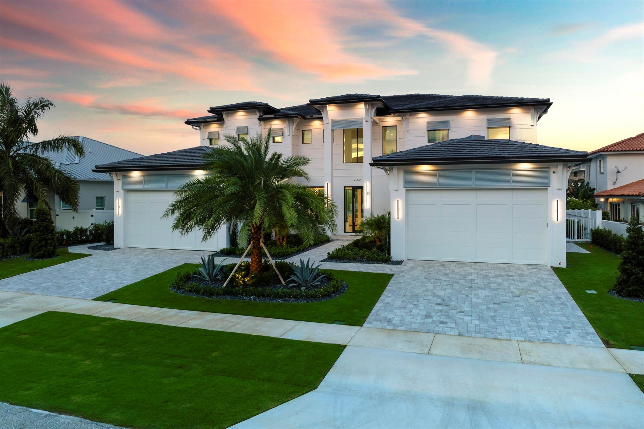 Modern Waterfront Estate in The Village of North Palm Beach. Discover a masterpiece of modern living in this stunning custom Vista Builders new construction home in North Palm Beach. Nestled in a prime waterfront location with direct ocean access, this exquisite 5-bedroom, Theater (Optional 6th bedroom),7-bathroom residence offers the ultimate in luxury and comfort. Indulge in 5,804 square feet of living space, including two gorgeous master suites. The gourmet kitchen, equipped with a Thermador appliance package and dual islands with backlit Cristallo Quartzite countertops, are stunning. The kitchen offers a convenient butler's pantry for effortless entertaining as well as multiple beverage and wine coolers.