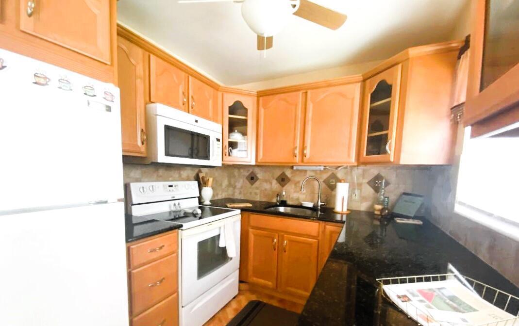 Updated 2-bedroom 1.1/2 bath second floor condo fully furnished in the heart of Century Village. Tile floor throughout, Kitchen Updated with wood cabinets and glass doors with central heating & air. This condo offers a light and bright corner unit. First bedroom offers walk in closet and patio doors leading out to an enclosed patio and Large second bedroom. There are laundry rooms on both the first and second floors with a spot for storage. Chatham J is financially sound and well managed. The amenities are endless from multiple pools to choose from as well as a beautiful indoor pool; Bike; Jog; Billiards; Bocce Ball; Clubhouse; Theater; Movies; Entertainment; Courtesy Bus; Game Room; Library; Pickleball; Sauna; Sidewalks; Street Lights and on and on! Lots of guest parking.