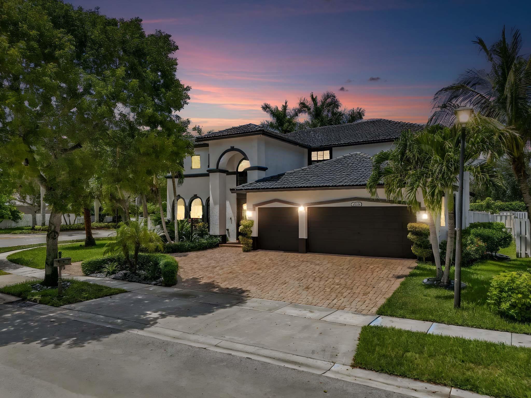 Welcome to the Kingston Plus Model Home—4BD/3.5BA with a 3-car garage & circular driveway in a gated, resort-style community. This beautifully maintained home has been freshly painted inside and out. It features hurricane-impact windows, sleek 2x4 porcelain tile on the first floor, and soft Berber carpeting upstairs. Dual staircases lead to a 500+ sq ft loft—perfect for a playroom, home office, or 5th bedroom. The gourmet kitchen boasts high-end finishes, brand-new appliances, and two full-size refrigerators(one in the kitchen, and one in the garage). Other highlights include security cameras, smart locks, electric vehicle charging station, upgraded garage door openers, a custom iron front door, and two new Carrier A/C units.