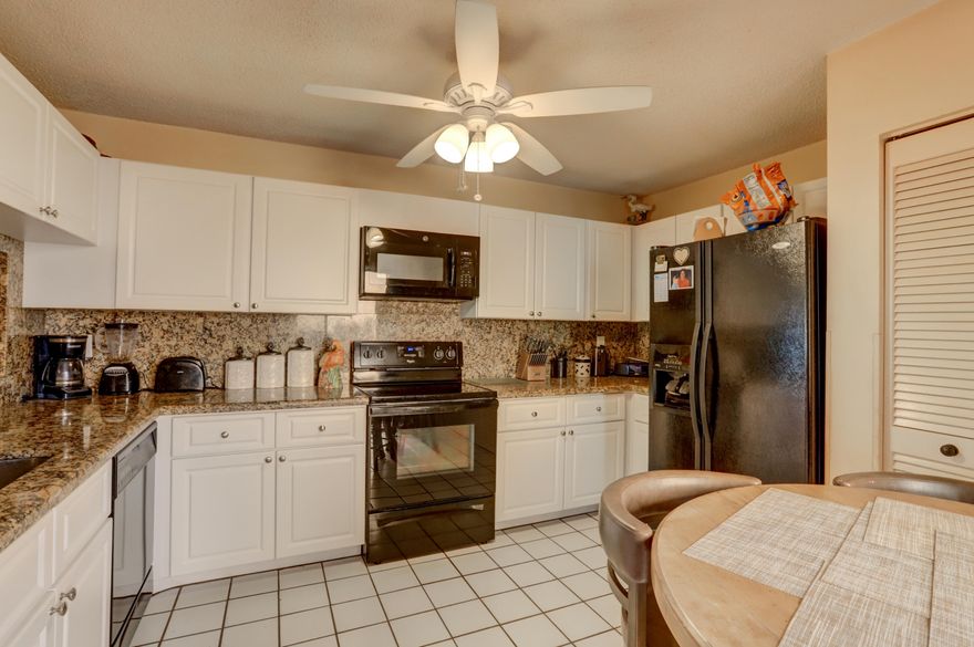 Location, Location, Location! Rarely available, All Ages, 3 Bedroom Townhouse featuring Expansive Water & Golf Views, Updated Granite Kitchen, Updated Granite Bath, Impact windows, Tile flooring, Pavered Entry Porch and Screened & Tiled Patio! Pets allowed (1 cat and/or 1 dog), Community Pool & 2 assigned parking spots. HOA fee includes monthly Pest control, Lawn, Insurance, Roof & Building Exterior. FHA/VA OK. Next to Woodmont Nature Preserve with Walking Trails, Dog Park and nearby Golf Course!