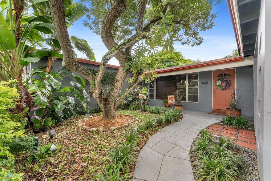 Charming 3BR/2BA single-family home in Margate with lush tropical landscaping and no HOA! Spacious living area with wood-style floors, large windows, and updated lighting. Kitchen offers ample cabinetry, stainless steel appliances, and dining area. Lovely Primary suite plus two generous bedrooms. Modern bathrooms include a remodeled walk-in shower with frameless glass. Enjoy Florida living in the screened patio, private fenced backyard, and pergola surrounded by greenery.  Perfect for entertaining. Added features: separate laundry room with full-size washer/dryer, 2 vehicle carport with extended driveway, and plenty of storage. Centrally located near shopping, dining, schools, highways, and beaches. Move-in ready!