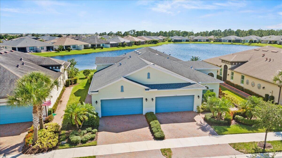 Discover this beautifully maintained 2 bedroom + Den, 2 bathrooms, 2 car garage villa in the vibrant 55+ community of Lake Park in Tradition. Featuring tile flooring throughout for effortless style and maintenance, this home also includes a newer A/C system for year-round comfort and a private garage.Enjoy breathtaking lake views from your creeened in lanai in one of Tradition's most desirable neighborhoods--a true gem offering comfort, convenience, and community.