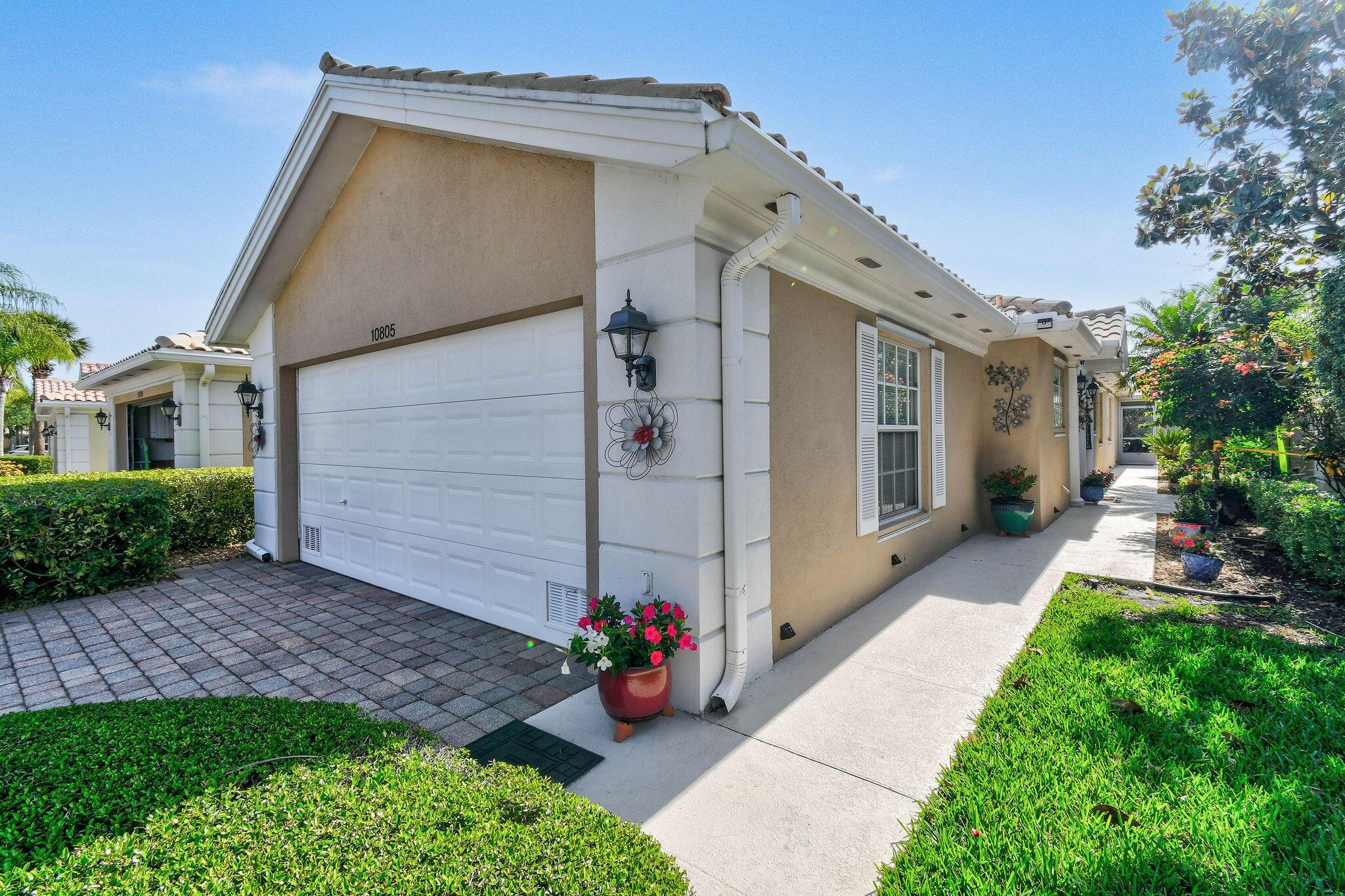 Move-In Ready Capri Model by DiVosta in the Lakes at Tradition!Welcome to your Florida retreat! This beautifully maintained 2-bedroom, 2-bath, 2-car garage home offers serene lake views and a relaxed, tropical lifestyle. Located in the desirable Lakes at Tradition community, this extended Capri model features additional living space perfect for entertaining or simply unwinding in comfort.Step out onto the screened, covered patio to enjoy morning sunshine and peaceful afternoons in the shade, with lush landscaping and gentle lake breezes as ducks glide by. Inside, the home features a neutral color palette, granite countertops in the kitchen, white tile flooring in the main living areas, and classic plantation shutters throughout.Used seasonally and in pristine condition, this