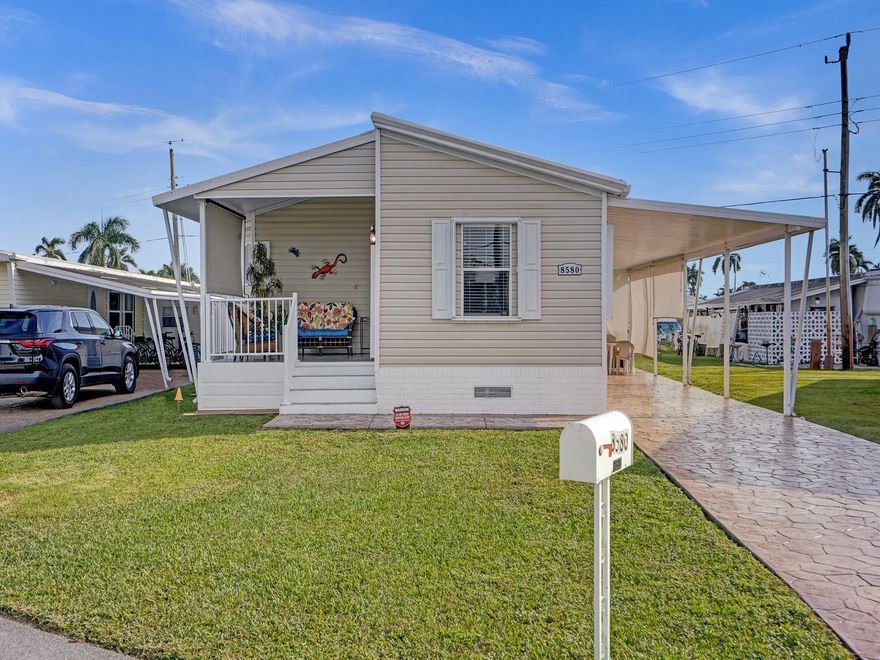 Absolutely beautiful double wide manufactured home in 55+ Park City Estates where YOU OWN THE LAND! Enjoy this lovely 2 bedroom 2 bathroom home with large carport and front porch to enjoy the Florida weather. <any windows bring lots of natural light into this home, and includes other upgrades such as open concept floor plan, spacious bedrooms, stamped concrete driveway, and more. House can be sold all furnished.