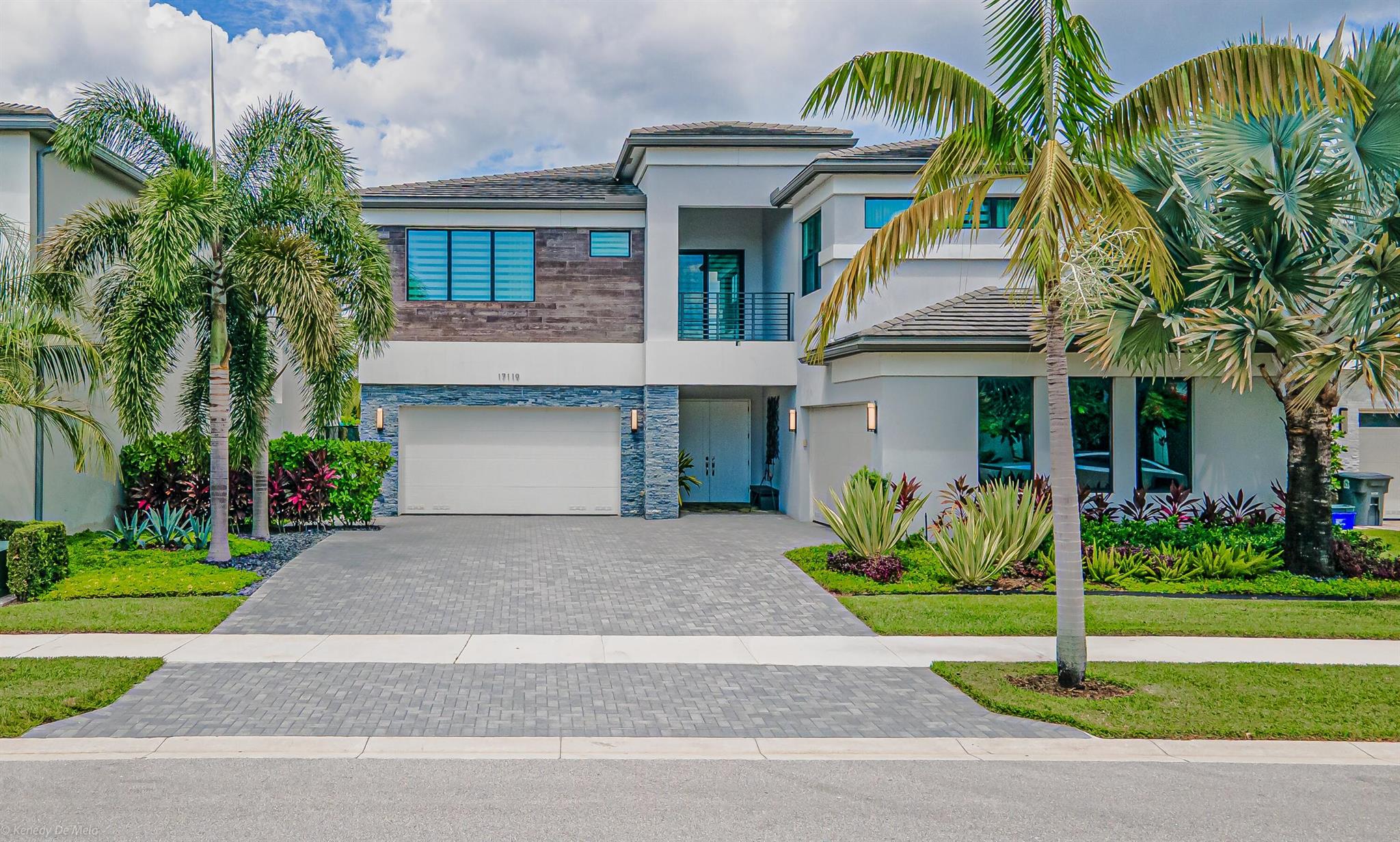 Fully furnished, turn-key estate delivers postcard sunsets over Lotus's widest lake. Every inch is smarter: giant porcelain slabs, natural-oak upstairs, double-height Scatto chandeliers, Toto smart lav. Tesla solar + Powerwalls cut FPL to under $100/mo; zoned AC. Gourmet Wolf/Sub-Zero kitchen, stone & wood accents, 500-bottle glass wine vault, 86-in screens, 2K/4K cams, ultra-short-throw theater. Outside: heated infinity pool/spa w/sun shelf & jets, travertine deck, audio, louvered pergola, Viking summer kitchen, living wall, turf play yard. Extended paver driveway to two 4-car garages + 4 outside spaces --climate-controlled workshop w/New Age cabinets, sink & fridge, plus Powerwall bay w/ceiling racks. EV chargers in both.Auto curtains & crown lights, 13 HD cams. Luxury lease unmatched.