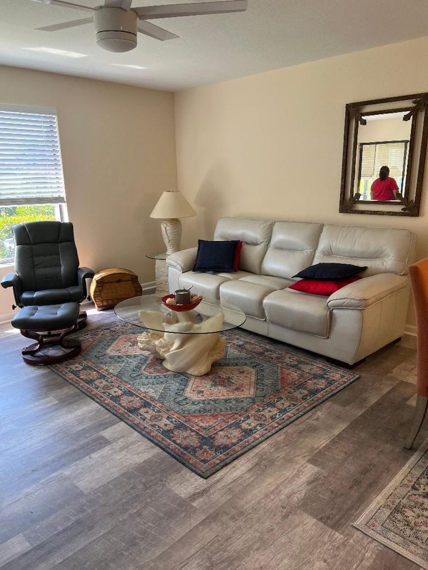 Wonderful first-floor 2-bedroom, 2-bath condo in the desirable 55+ community of Miles Grant. This light and bright unit offers true ground-level living with assigned parking directly in front of the unit for ultimate convenience. Updated bathrooms, ceramic tile flooring throughout, a fully enclosed lanai with impact sliding doors and windows that opens to a private patio overlooking the golf course—perfect for morning coffee or relaxing evenings. The home also features newer A/C, water heater, dishwasher, and washer/dryer. Miles Grant is an active and welcoming community located near the Intracoastal Waterway in Stuart. Residents enjoy a community pool and a mandatory social membership to Miles Grant Country Club, offering options and a wide range of amenities including pickleball