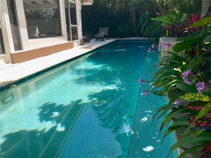 Lush, Private, Tropical, Gated Paradise in Highly Desirable Victoria Park Truly  a Hidden Gem!  All Impact Windows & Doors & 2018 Air Conditioner.  Interior Features a Stunning Ornate Carved Stone Fireplace, Vaulted Beamed Ceilings, Built-in Bookcases w/ Designer lighting, Lighted Art Niches, Hardwood Floors, Archways Thru-Out, Sky Light, & Crown Moldings.  Family Room has Floor to Ceiling White Built in Book Cases for Art Work, Books,  Collectibles & TV w/ Designer Lighting, Pebbled Tile & Walls of  Impact Glass Windows Showcasing all the Lovely Gardens.  Custom Kitchen w/ White Washed Louvered Cabinetry, Glass Tiled Back-Splashes, Bosh Dish Washer & Granite Counter Tops.  Double French Doors lead to Screened Porch w/ High Beamed Ceiling.  7X38 Lap pool & Spa. Termite Guarantee on Home.