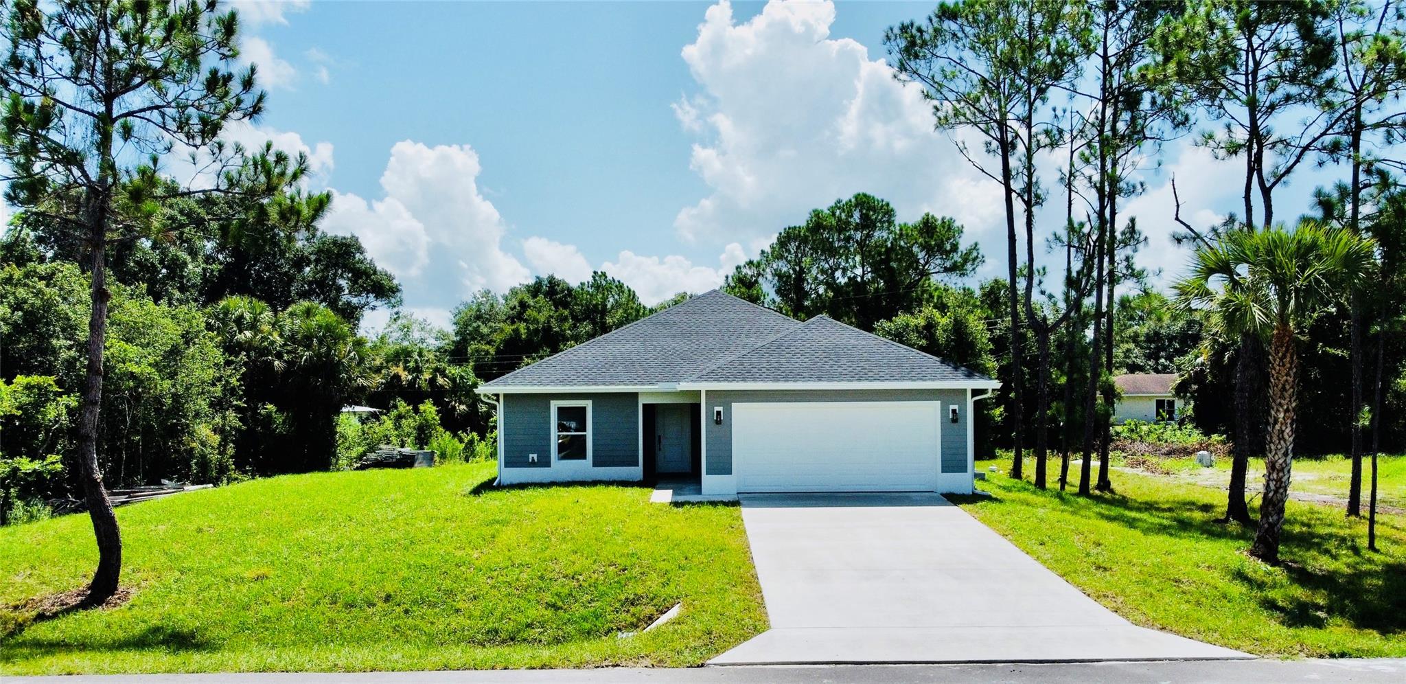 2025 NEW CONSTRUCTION-We welcome you to tour this brand new MODERN 3BR/2BA home. The builder intended to check off all the boxes with an open floor plan, large kitchen island, foyer, pantry closet, covered front porch for amazon deliveries, 2-car garage, covered back porch perfect for family gatherings and impact windows for safety, security and convenience during hurricane season. This CBS home is built on an oversized lot with pine and oak trees offering peace and quiet at the end of a calm street. Additional features include gutters all the way around pre-installed by the builder, and spray foam insulation to help lower the electric bill in the hot summers with a washer and dryer included from the builder, truly a stunning turnkey home opportunity.