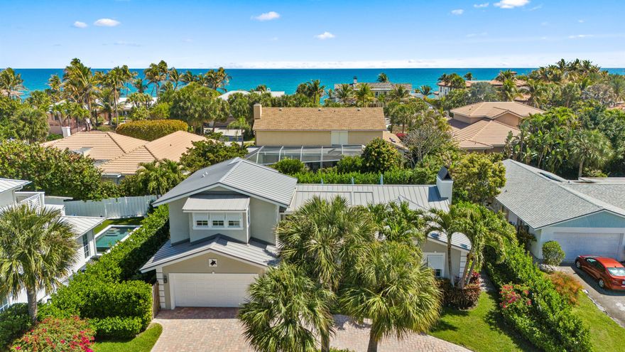 Located in the exclusive seaside community of Jupiter Inlet Colony, this beautifully updated traditional home sits on a quiet, private lot at the southern tip of Jupiter Island—just steps from the community beach access and within walking distance to the Jupiter Inlet.  This meticulously maintained 4-bedroom, 3.1-bathroom two-story home was fully remodeled in 2023 and offers abundant natural light and an open floor plan that creates a seamless flow throughout the home. The light and bright living room features a wood-burning fireplace and flows seamlessly into the kitchen with all new appliances—perfect for both everyday living and entertaini Interior highlights include brand-new flooring throughout, volume shiplap ceilings, impact windows and doors, and custom lighting. SEE MORE REMARKS.. The first floor features the spacious primary suite with a private en-suite bathroom, along with two additional guest bedrooms. The second floor offers a large fourth bedroom with its own en-suite bathroom and a versatile loft area—perfect for guests, a home office, or additional living space. Outdoor living areas are designed for relaxed island living, with lush landscaping, private patio spaces, and a large open terrace that extends the living area outdoors. A splash pool completes the tropical setting, creating the perfect space to unwind or entertain. The Jupiter Inlet Colony is a serene, exclusive waterfront community with its own Police force and is surrounded by 3 bodies of water; the Atlantic Ocean, the Jupiter Inlet and the Intracoastal. This community provides private beachfront access, lush tropical landscaping, and tranquil ambiance.