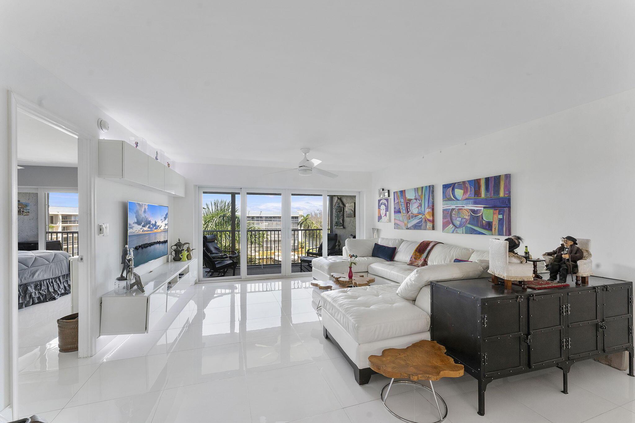 Your perfect waterfront condo awaits. Come see this beautifully renovated 2-bedroom, 2-bathroom condo. It features a bright, open floor plan with gleaming white tile flooring throughout and plenty of natural light. The kitchen has sleek white cabinetry and appliances, including a built-in oven and cooktop.