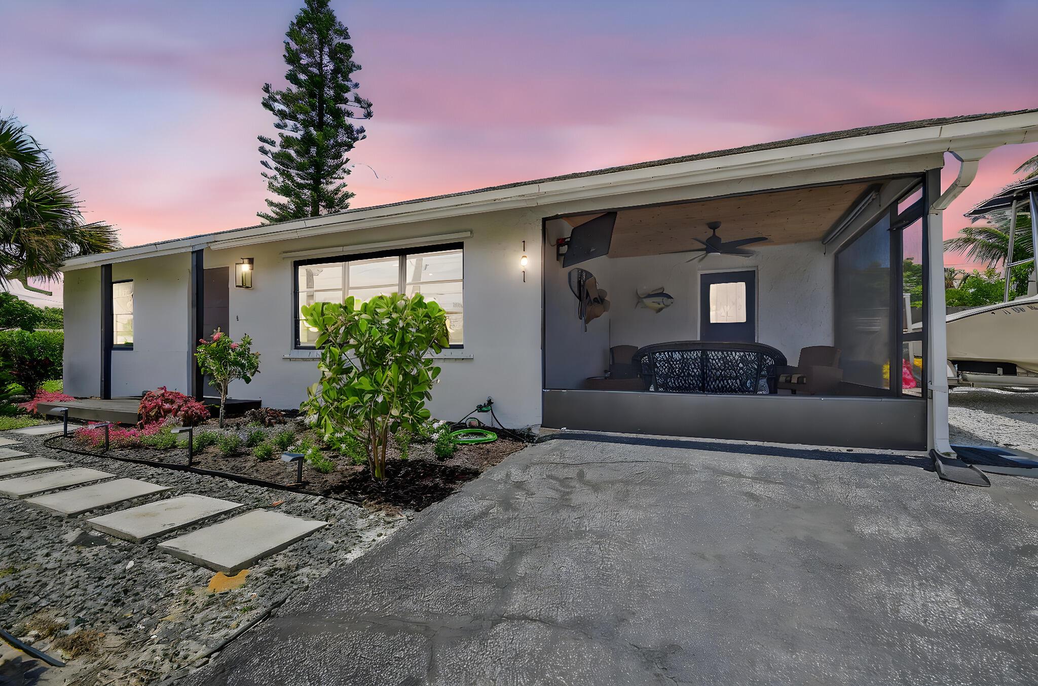 Welcome to this beautifully renovated 2 bedroom, 1.5 bath home with NO HOA in Boynton Beach! This home features a corner lot, and modern upgrades throughout. Step into the open-concept living space featuring tile flooring, and new interior paint throughout with a living room, formal dining and kitchen. The kitchen upgrades include Butcher's Block countertops, subway tile backsplash, deep sink, and bar area with seating for those quick meals on the go. The bedrooms both have ceiling fans, and the whole house has smart lighting with different settings controlled by your phone. The bathrooms have been tastefully upgraded along with the inside utility room which includes cabinets for storage. With ample parking for a boat or RV, a fenced lot, and a lush variety of plants, trees and a