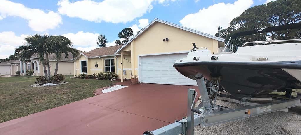 Photo of 1514 SE Manth Lane, Port Saint Lucie, FL 34983 (MLS # R11092871)