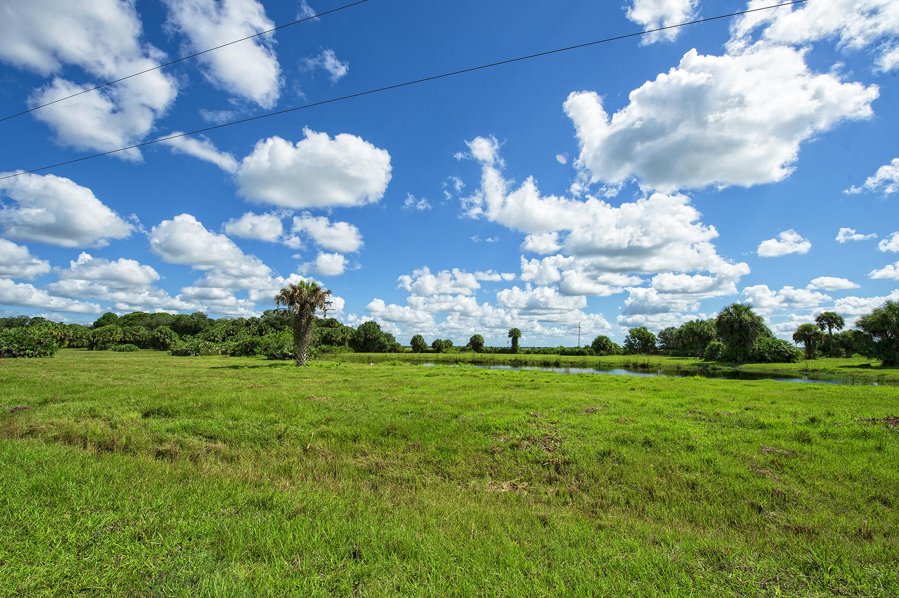 250+ acres of Freedom! Heading for your Country Retreat in Martin County! This ultimate country lifestyle can be yours! No HOA. Bring your animals, toys & hunting gear. Feel like you are in the middle of nowhere yet only 12 minutes to I95; close to Palm City, Indiantown & Okeechobee (world class fishing, Lake O!) See the sunset, see all the stars sitting on the porch of the 4/2 modular or practice shooting on the range with bathroom & storage. Imagine driving your 4 wheeler thru massive old trees & picturesque meadows or follow along the beautiful creek meandering thru the land scouting out the Osceola turkeys, white tail deer, hogs & more. Farm, hunt, play or relax when you own the land you decide what to do. South Florida great opportunity. See drone video of the 3 parcels, for 250+ Ac.