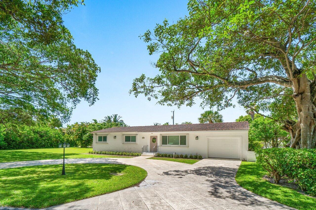 Hypoluxo Island: 3-bedroom, 2-bath home with a 1-car garage, situated on a spacious lot. Recently updated with new impact windows, renovated bathrooms, and new kitchen appliances and countertops.