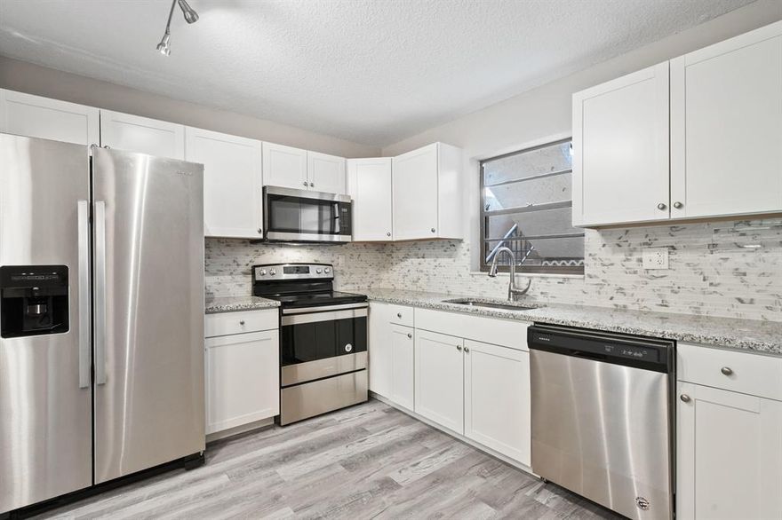 This 2br 2 bath condo is spectacular in the most desirable 55 plus South Stuart  Community of Twin Lakes on the 1st Floor with Granite, Luxury vinyl Flooring, New Kitchen,  with Stainless Steel  Appliances, Open floor plan all New custom Baths Newer A/C, New Hot Water Heater. New Lighting,,Freshly painted. Great Location Covered Parking Close to shopping, dining, beaches.  Community has Gym, Clubhouse, Pool, Rec Room, Tennis. Very well kept. All Measurements Approx. This is a must see.