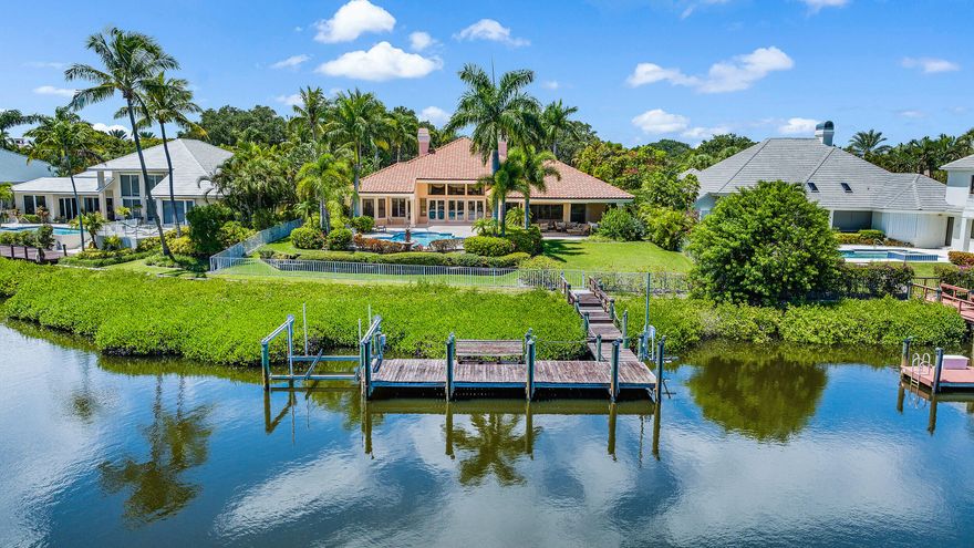 Custom Waterfront Estate Home with convenient location close to the main gate and clubhouse. If you like large, bright and sunny rooms then this property is the one for you. Lavish Owner's Retreat overlooking the waterway, with sitting room, 2 walk in closets, 2 baths, granite countertop, large tub and tons of storage.  2 oversized guest suites with private baths, large closets and are located off their own wing.  Lush tropical landscaping surrounds the expansive backyard that provides beauty and privacy.