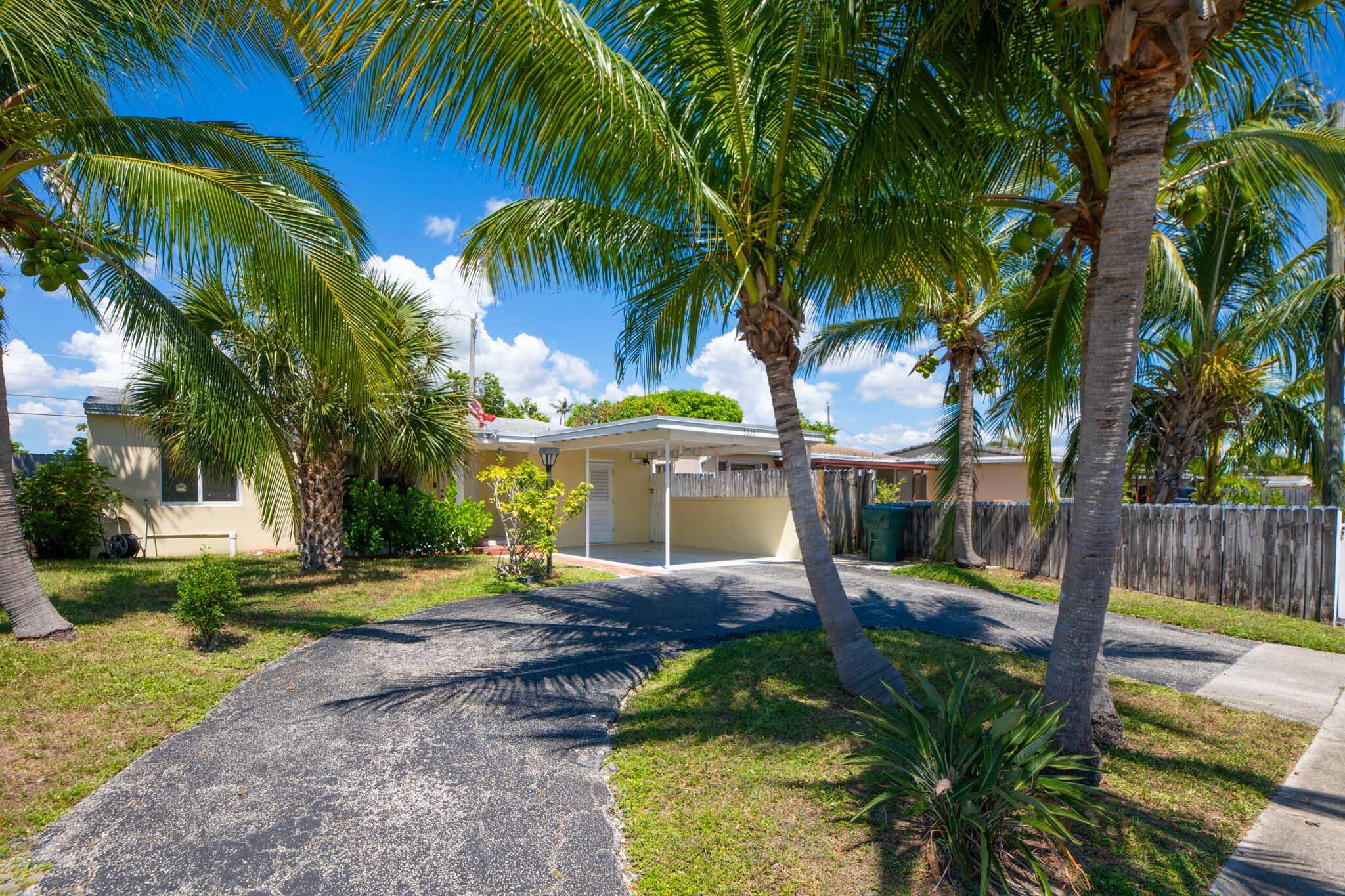 Updated within the last 6 years, this sunny and spacious 3-bedroom, 2-bath home features impact windows, a newer roof, and stylishly renovated kitchen and bathrooms. This home is move-in ready and awaiting its new owner. Enjoy ceramic tile in the main living areas, ceiling fans throughout, a kitchen with an abundance of storage, a separate dining area, plus a bonus room. The primary suite boasts an oversized shower, while both baths are accented with gleaming white subway tile. Relax outside in the charming backyard on the large deck that is perfect for outdoor dining and entertaining. Circular driveway and carport allow for plenty of parking for your weekend gatherings. Shown by appointment only.