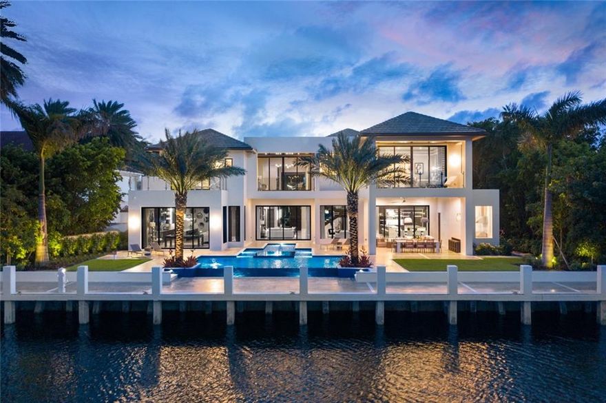 NEW CONSTRUCTION HOME. FINISHED AUGUST 2020 Waterfront estate designed by renowned architect Randall Stofft. This home marries a modern aesthetic with organic finishes to exude elegance and warmth. This 8,273 SF AC estate features a lavish master suite with dual master baths and closets. This furnished estate provides extraordinary amenities, including spacious clubroom with wet bar, elevator, 7-seat theater, 560 bottle wine room & pet grooming area. Chef's double island kitchen includes Miele & Wolf appliances. Located in Harbor Beach, a private beach club community, this modern estate is situated on one of the most sought-after streets. The oversized lot offers 105' WF on an ultra-wide canal. Summer kitchen, outdoor dining and infinity pool. Home comes turnkey furnished