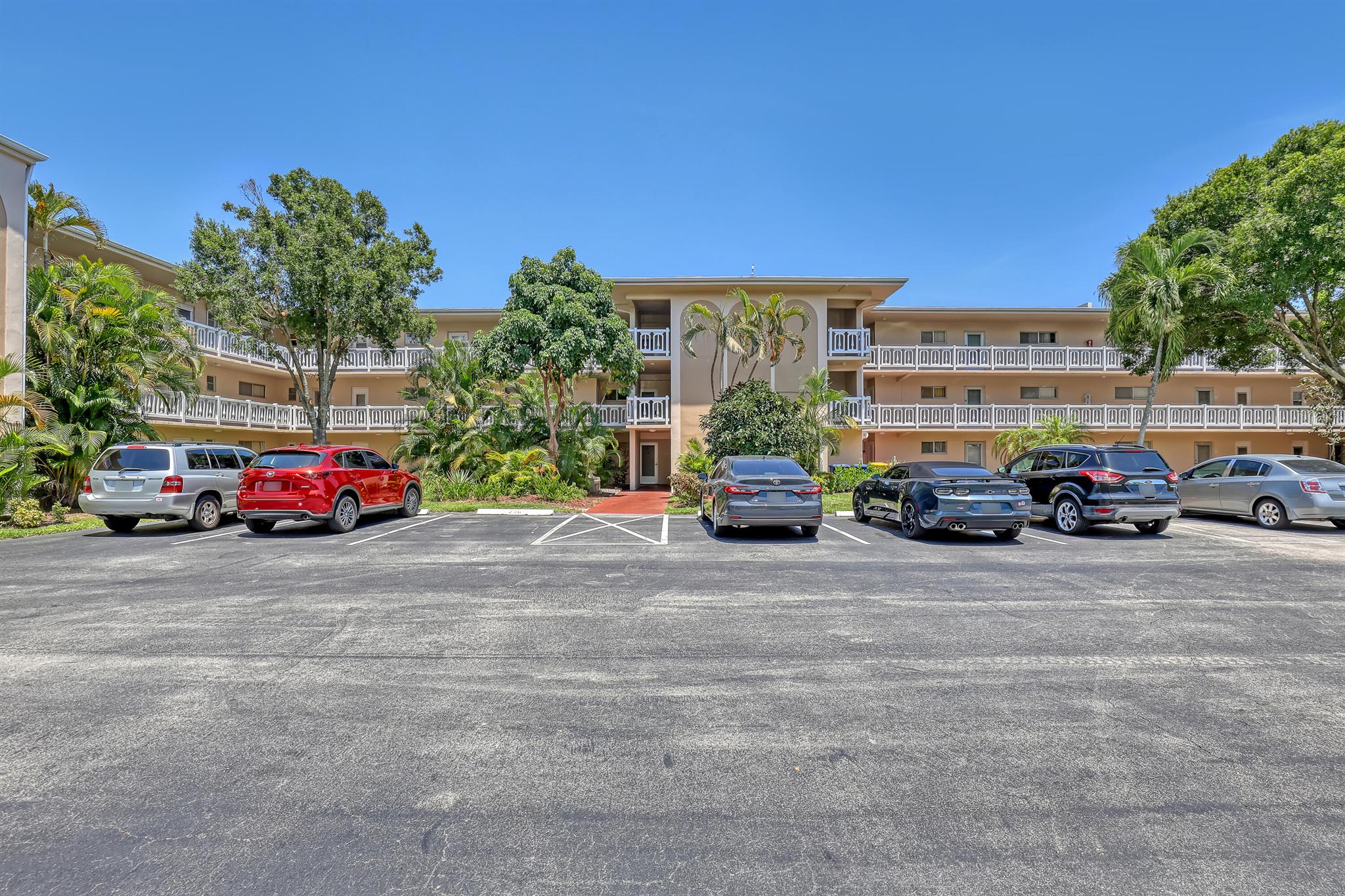 Beautifully renovated and thoughtfully designed, this elegant condo in Lake Clarke Gardens offers modern comfort and charm. Enjoy brand new wood floors, a fully remodeled kitchen with never-used stainless steel appliances, quartz countertops, and custom cabinetry. The updated bathroom features new fixtures, and the master bedroom includes a spacious walk-in closet with built-in storage. A French door leads into the second bedroom, perfect as a guest room or home office. The enclosed balcony features a stunning newly tiled stone floor--an ideal space for morning coffee, a glass of wine, or an intimate dinner for two. With new ceiling fans, an alarm system, and sophisticated details throughout, this move-in ready unit is a true gem.