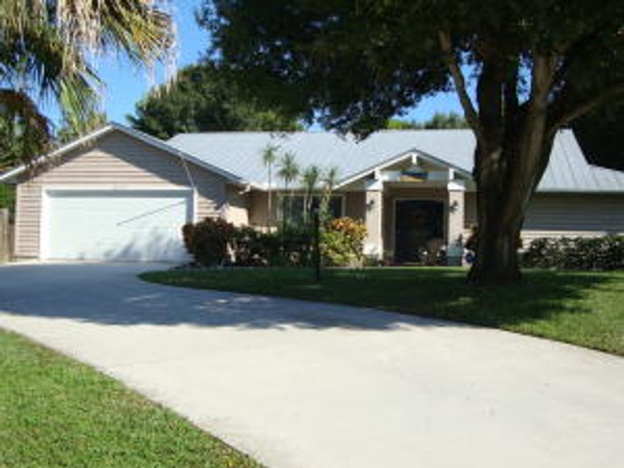 Beautiful Pinecrest Lakes Community with 2 Parks, basket ball courts, picnic areas and tennis courts for residents. Very large 4 bedroom, 2 bath, 2 car garage ranch with Key West Decor sitting on over a half acre lot. It has a large open patio and pool with safety fence and an enclosed screened patio. Large open- split floor plan inside. Beautiful natural stone fireplace in the great room with high volume ceilings and custom shelves, Beautiful oak floors through-out. Lots of closets and storage. Washer and dryer in garage. This home is move-in ready and priced to sell. This home is located within minutes of Treasure Coast Mall, downtown Jensen Beach and the ocean. Hurricane shutters included. House has regular pest control and termite inspection for prevention.