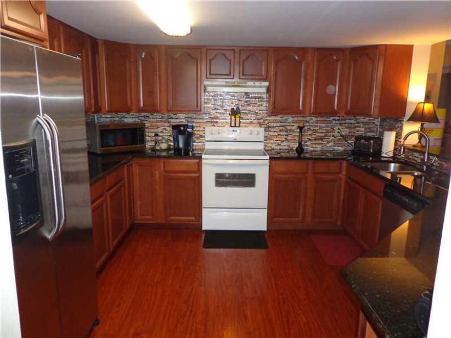 Gorgeous 3/2 condo, spacious, clean and neutral. Desirable 2nd floor on beautiful wide lake. Mega kitchen, granite countertops and wooden cabinets. Open concept living room & dining room with nice screened patio overlooking lake. Beautiful views from all  rooms overlooking lake, fountain & pool/clubhouse. Walk in closet in spacious master bedroom. Tiled throughout. This light and bright unit features 2 assigned parking spots.