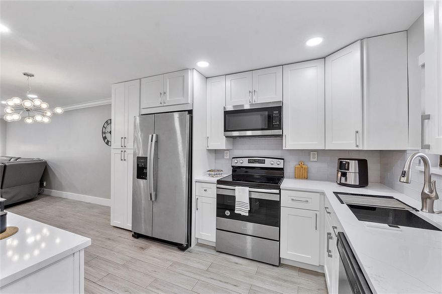 True Pride of ownership! This stunning condo has been completely renovated from ceiling to floor. This home has been upgraded to porcelain plank floors, new closets, crowd molding, solid wood shaker cabinets, motorized blinds, new washer and dryer, brilliant LED lighting, inspired showers and vanities with brushed nickel faucets. This masterpiece, has an enclosed balcony that is ideal for a home office with a relaxing and captivating view of the golf course. This property also boasts a new AC system and a modern tankless water heater, adding to its appeal and efficiency. Last but not least, this property stands out presenting an exceptional investment opportunity due to its absence of rental restrictions. Association fees include internet, cable, water and pest control.