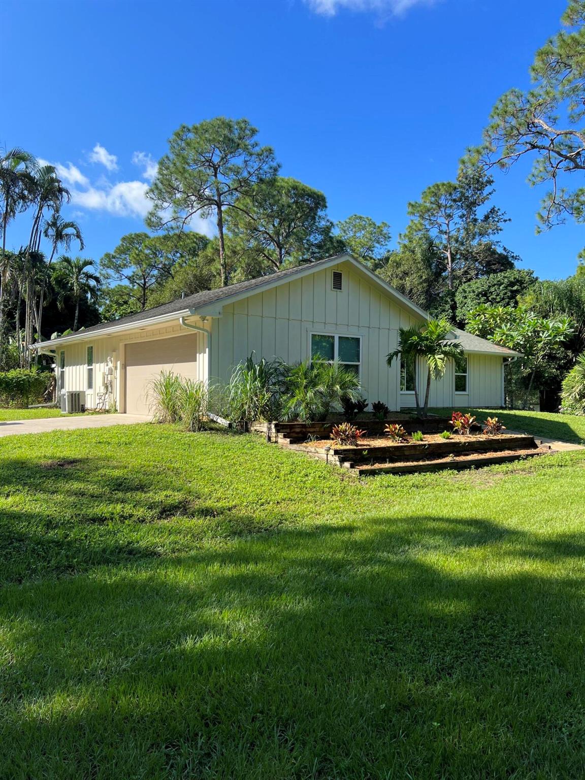 Perfectly located remodeled 3br/2ba Single Family Home rental in the Jupiter Farms situated on 1.25 acres. Quiet & private property. 2 car garage. Fully fenced yard. New stainless-steel appliances. New tile floors throughout. Upgraded kitchen & bathrooms. Screened patio. Beautiful landscape with lawn maintenance included in rental price. No restrictions. No HOA. Pets, horses, trucks, commercial vehicles welcome. Located close to Publix grocery store, community park, Riverbend park & trails, 5 minute drive from I-95 & Turnpike in Jupiter. 15-20 minute drive from beautiful Jupiter Beaches. One of a kind property. Great for anyone seeking nature, landscape, land, space and privacy.