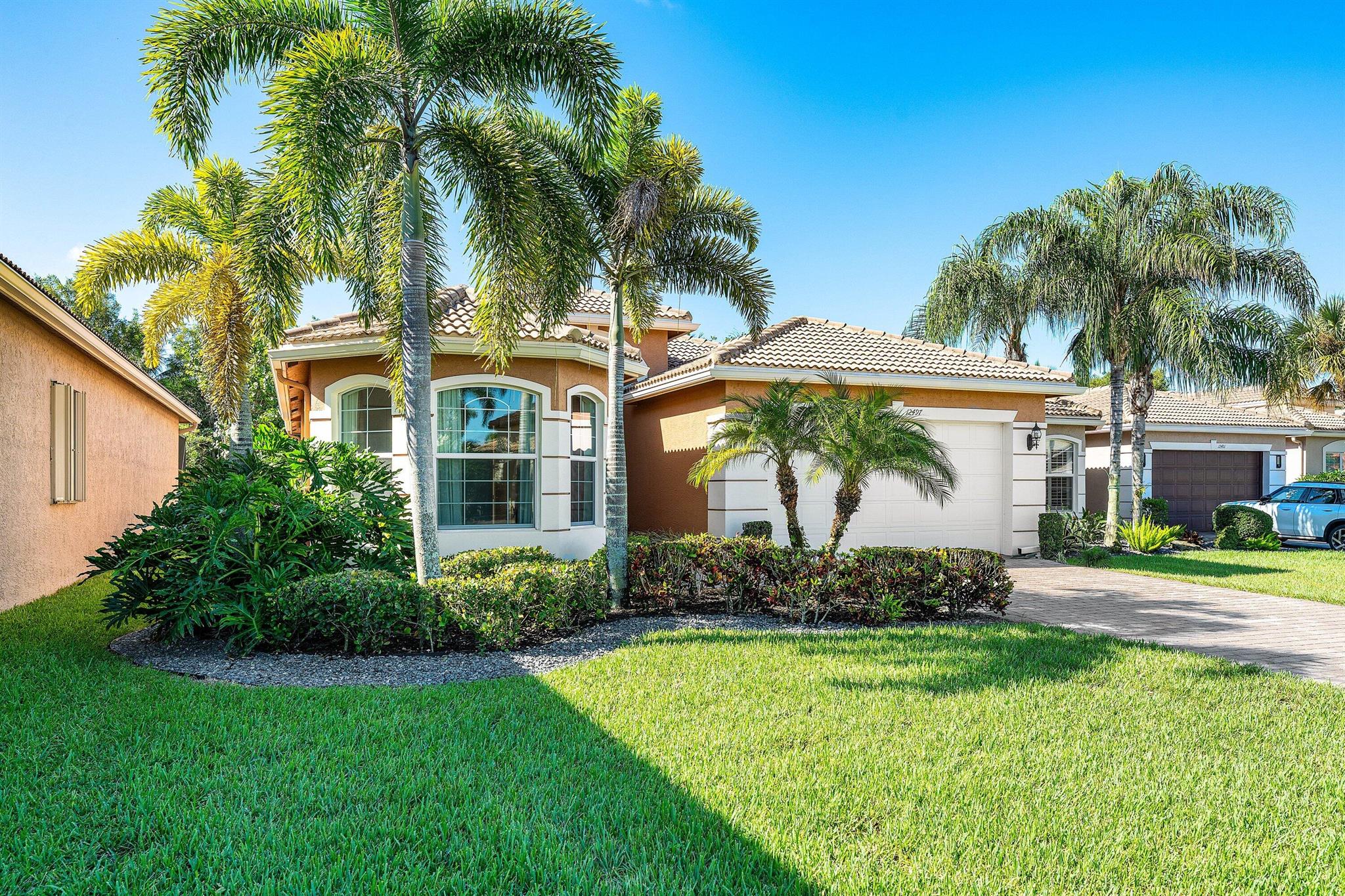 This lushly landscaped 3 bedroom+den Gibralter model sits on an oversized private lot backing south. Features include porcelain tile, transom windows, fans, hi-hats, window treatments, upgraded baths and more! Formal living room and dining room. The chefs kitchen features wood cabinets, granite countertops, glass tile backsplash and all the bells and whistles! There are upgraded appliances including a double oven, brand new dishwasher and microwave and a six year new Samsung refrigerator. There is a snack bar with pendant lights and a separate breakfast area with bay window. The great room, with French doors, is open to the kitchen. The master suite has a luxurious bath with wood cabinets and marble countertops. You'll love the covered screened porch and fenced heated, salt water pool.