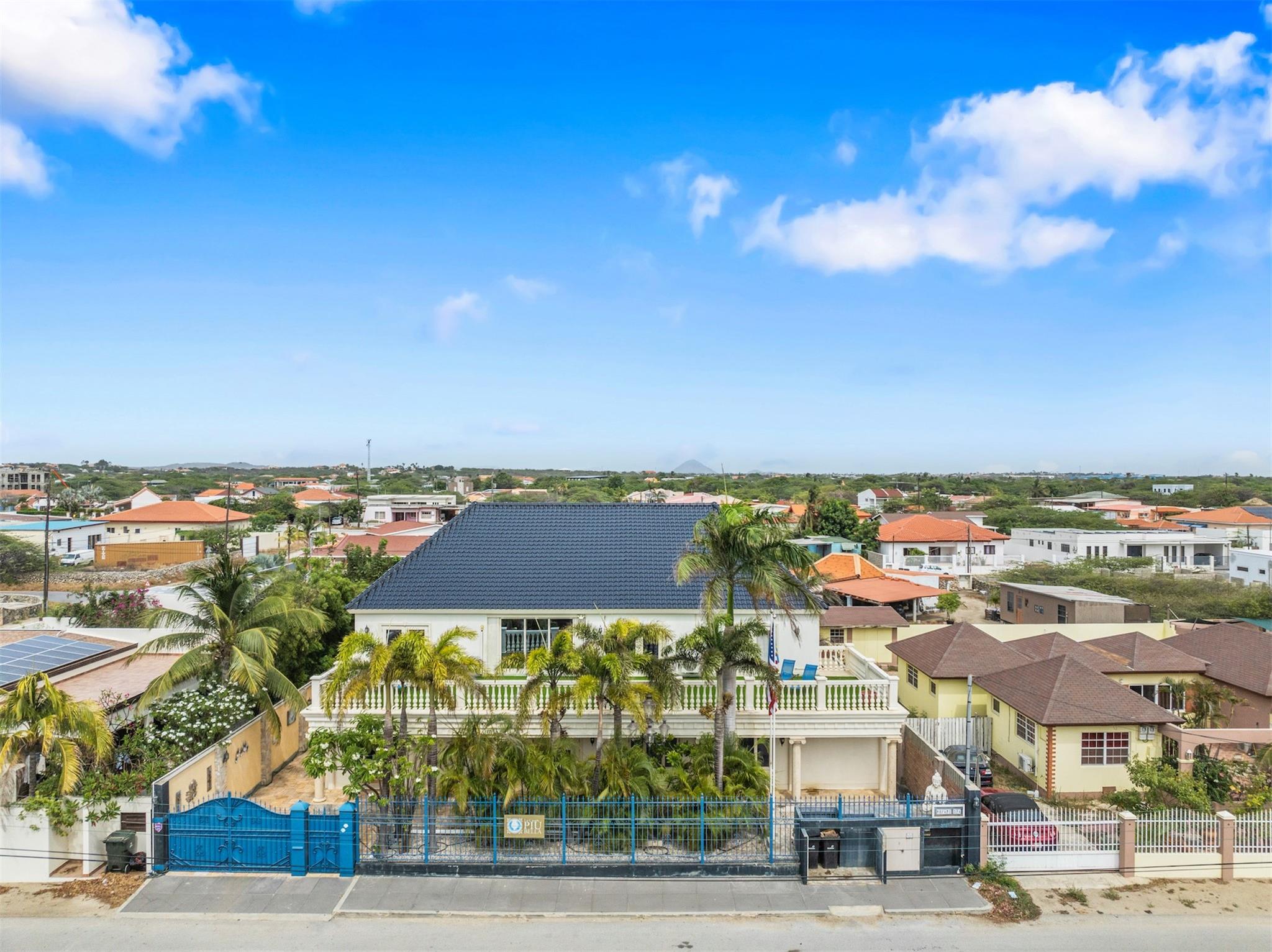Welcome to La Casa Più Bella—an exquisite 8-bedroom, 4.5-bath villa in Aruba’s Koyari neighborhood, minutes from Palm Beach and the island’s lively hotel strip. Currently a thriving Airbnb with good returns, this turnkey retreat is perfect for extended families or investors. The interior offers a spacious layout, modern kitchen, and multiple lounging areas. Step outside and you’ll find your private resort: a sparkling pool, soothing jacuzzi, palapa for shaded relaxation, full BBQ setup, and a tropical garden. Guests enjoy an outdoor shower and dedicated changing room for comfort and convenience. Whether hosting or unwinding, this property delivers an unmatched island lifestyle—serene, beautifully landscaped, and close to beaches, restaurants, and nightlife. Live the dream and earn from it!